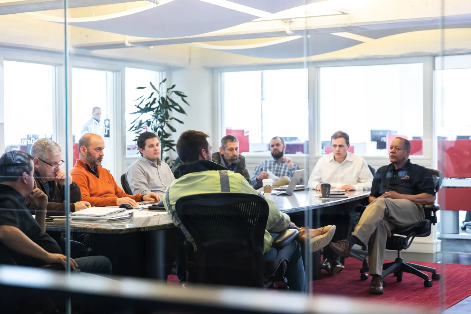 McCownGordon associates sit in meeting discussing construction and preconstruction