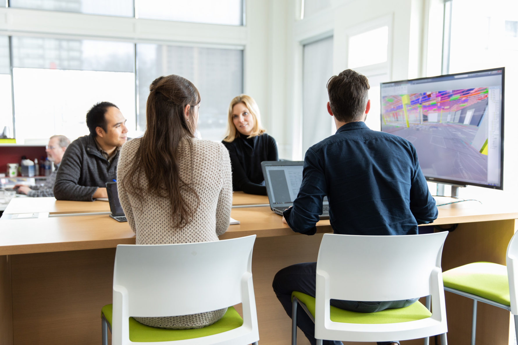 four employees working on design plans