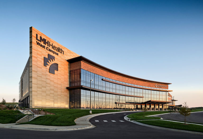 LMH Health West during sunset. The sunset is reflecting off of the many windows