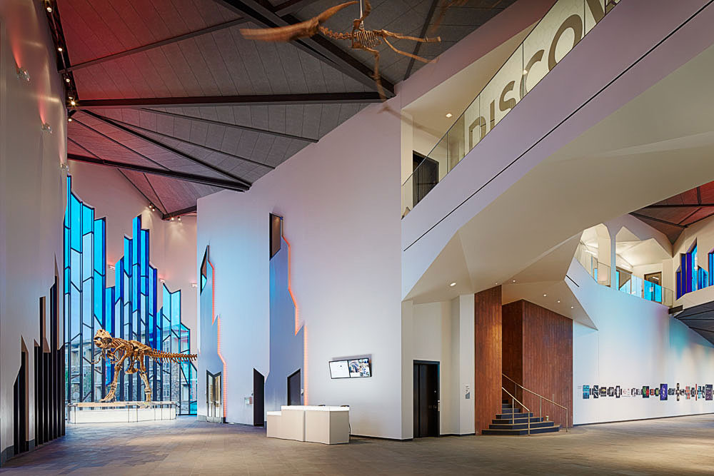 The main lobby of Prairiefire Museum, built by McCownGordon, displays a full-scale cast of Tyrannosaurus Rex.