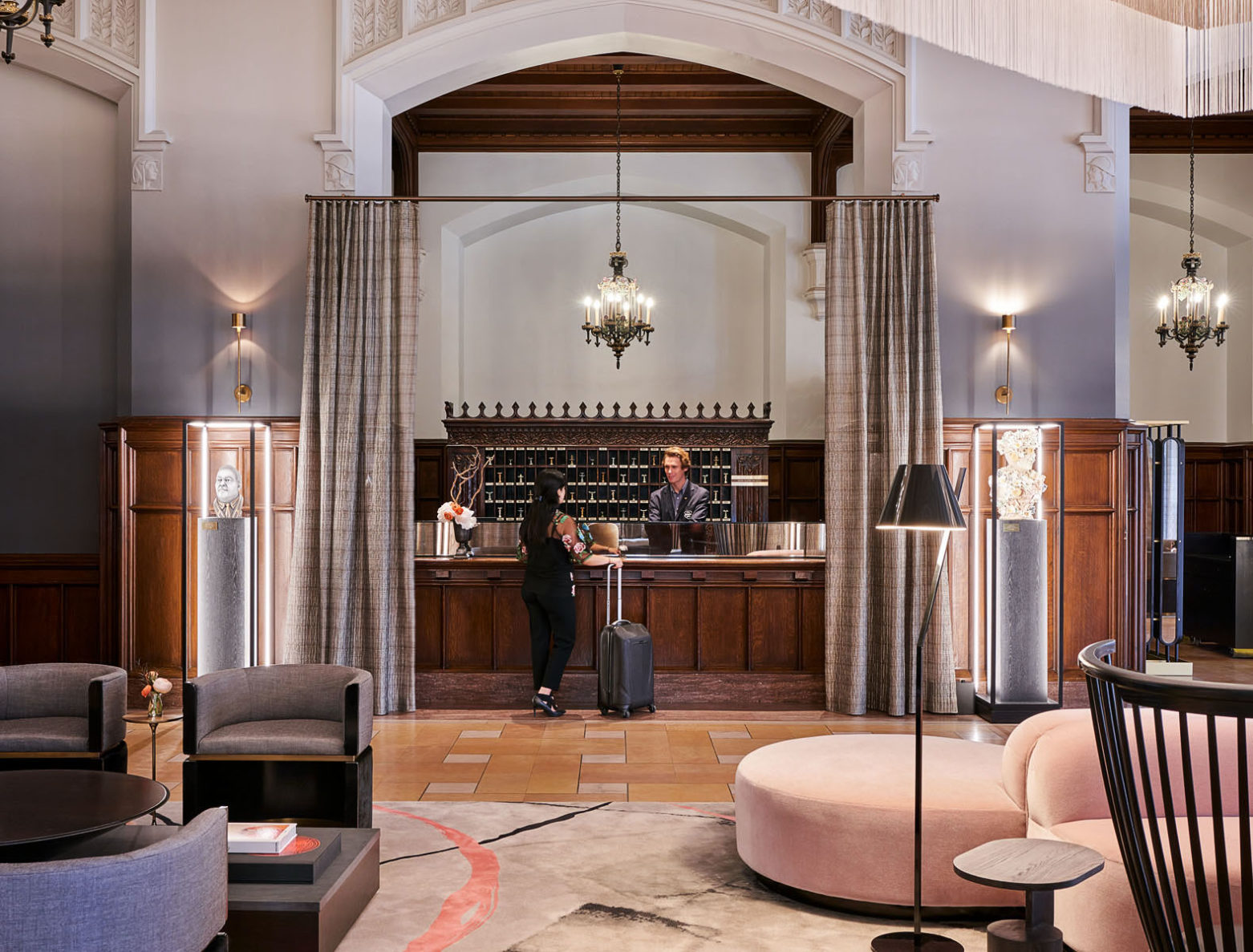 A guest being greeted at the front desk of Hotel Kansas City, built by McCownGordon