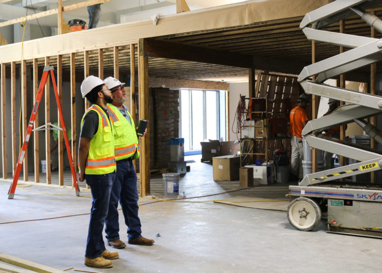 Two male McCownGordon men check on a project