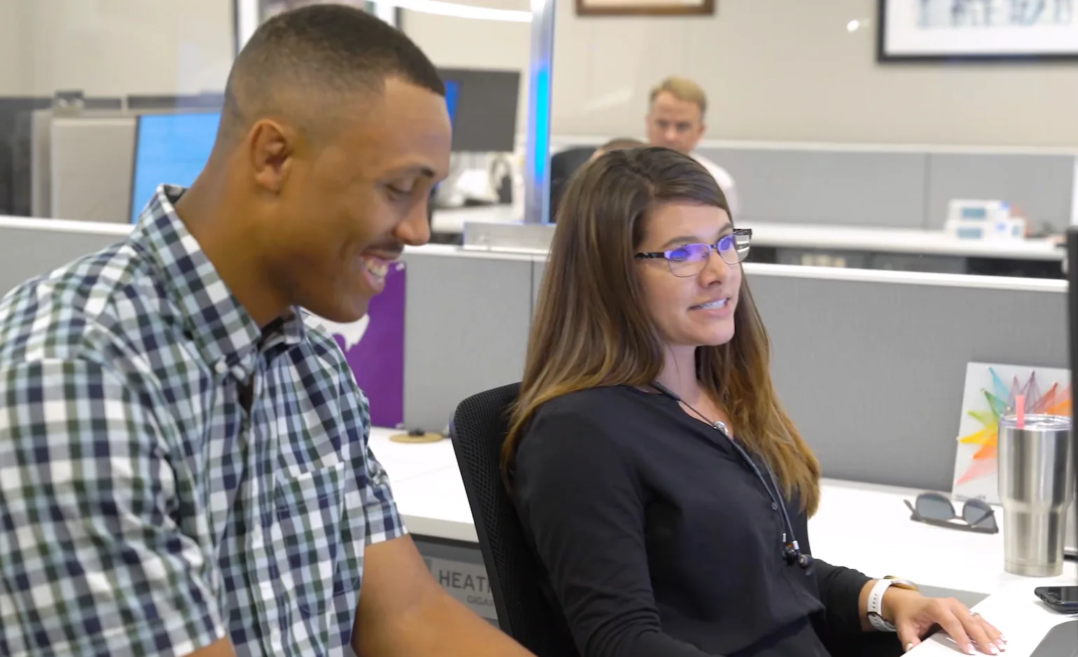 Two McCownGordon associates talking at a computer in Manhattan Kansas
