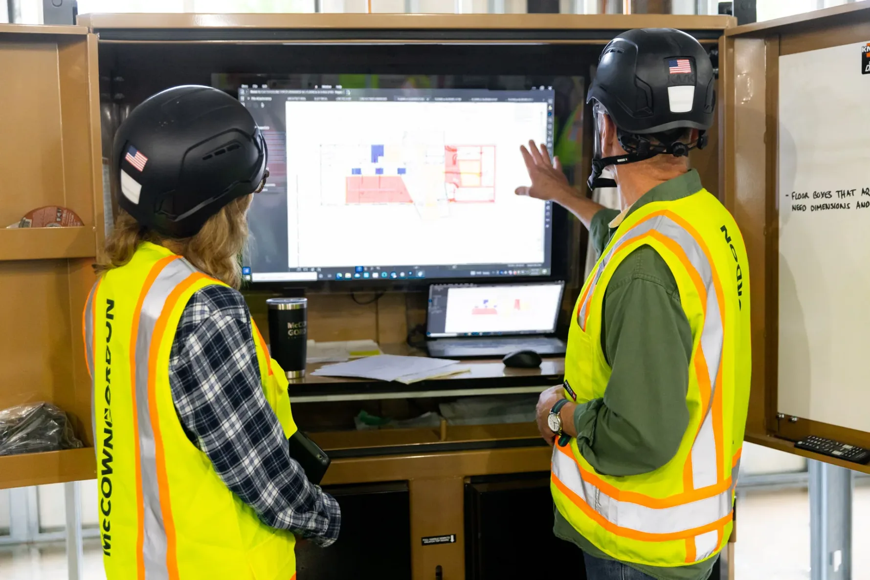 Two McCownGordon associates looking at digital construction plans while on a jobsite