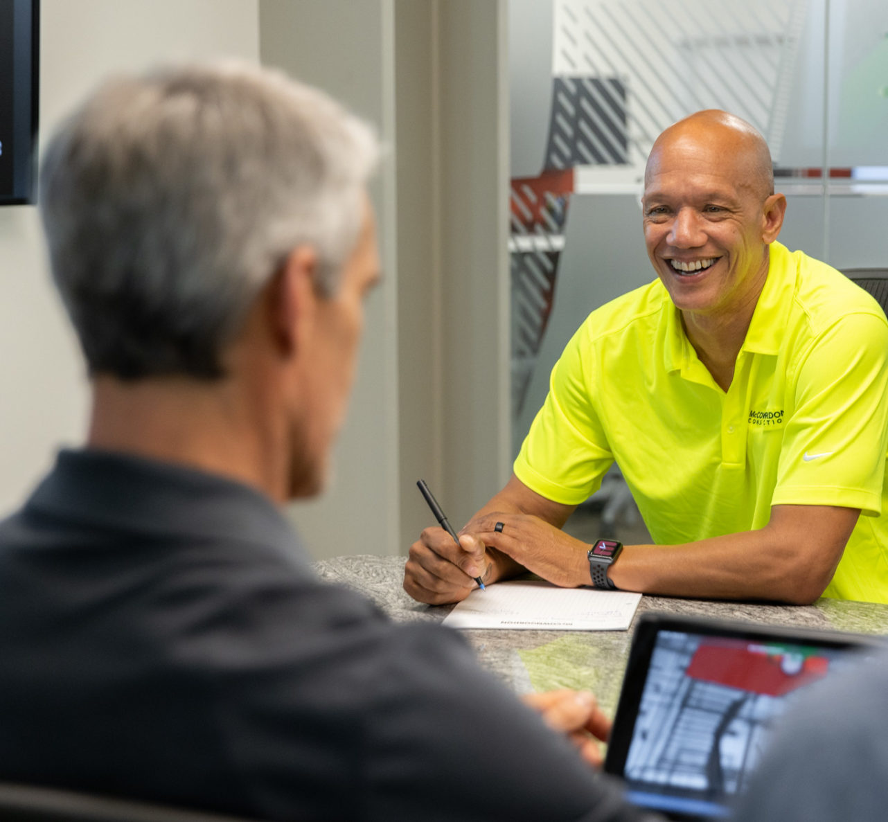 McCownGordon associates laughing and collaborating in the office