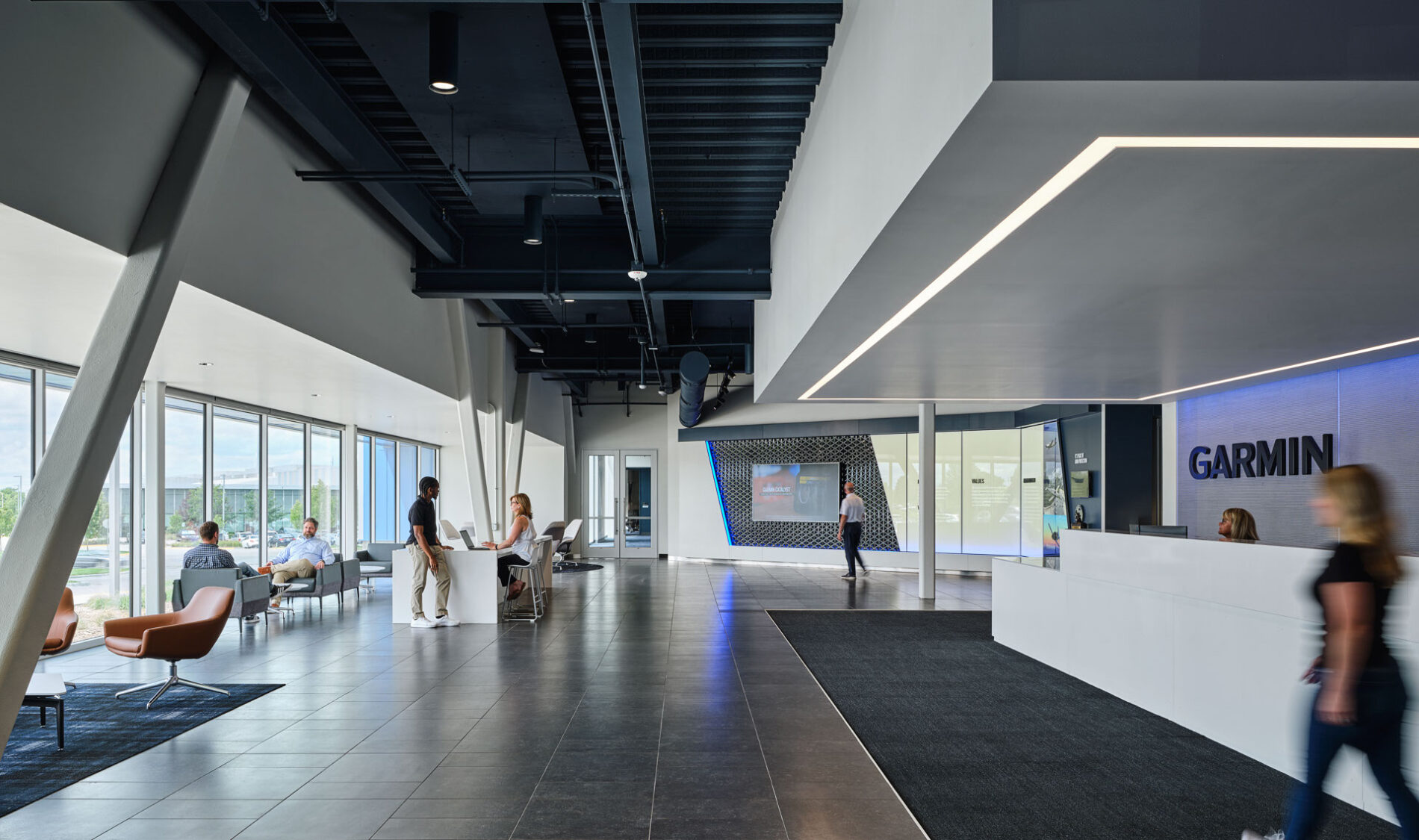 Associates walking around and talking in the lobby area at Garmin's corporate headquarters campus