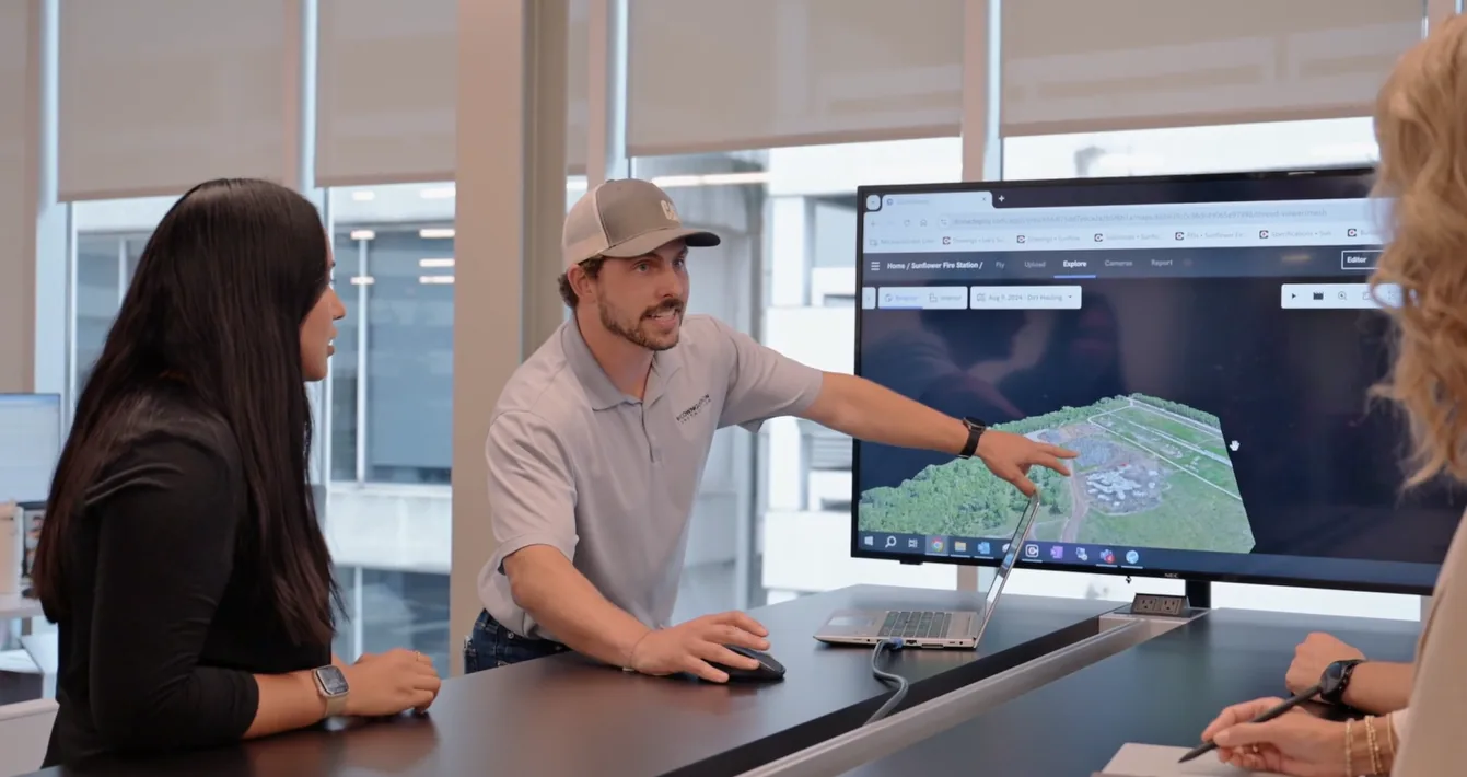 McCownGordon Construction associates collaborating and looking at a site analysis on a screen