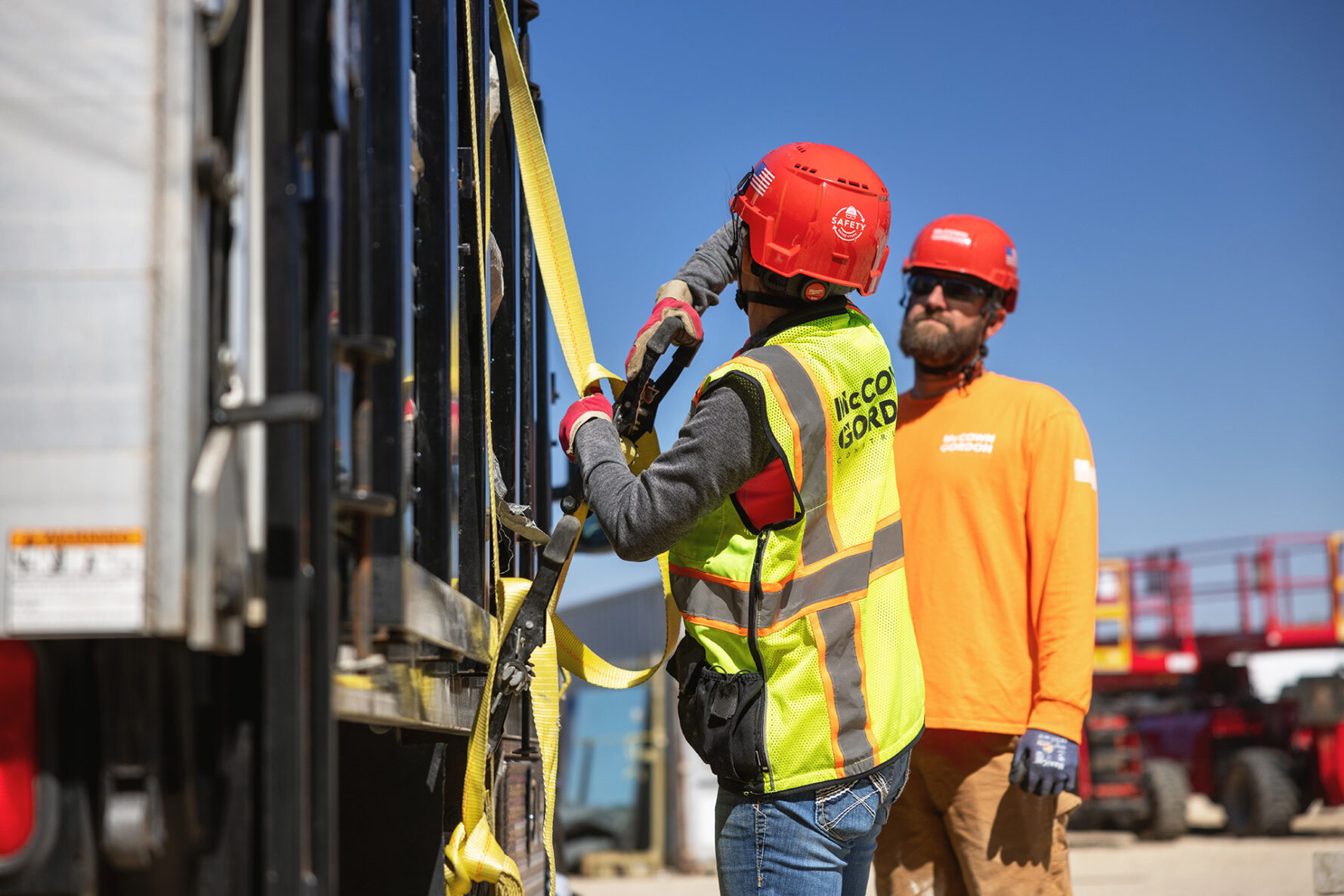 Two McCownGordon construction workers unloading manufacturing materials.