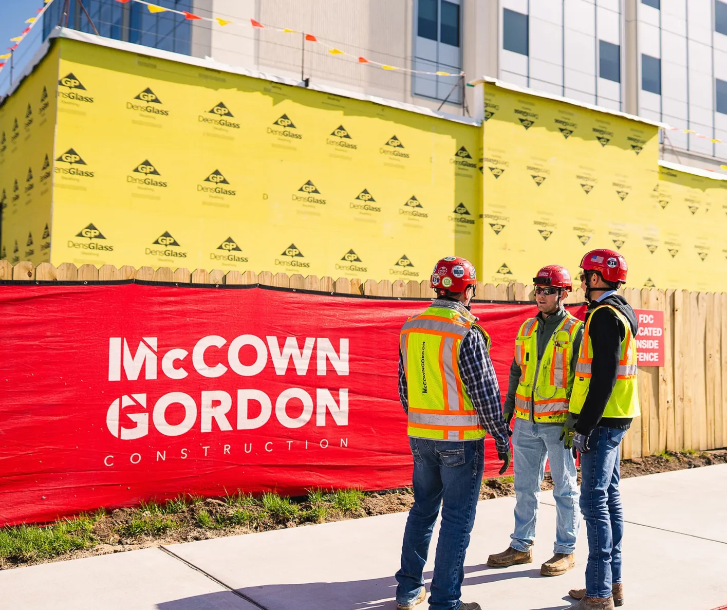 McCownGordon construction workers talking by jobsite work.