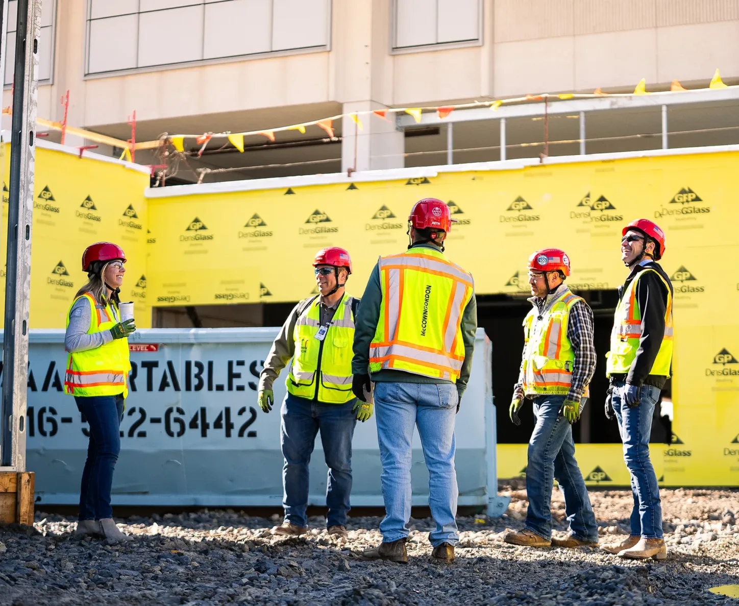 Five McCownGordon associates collaborating on jobsite.