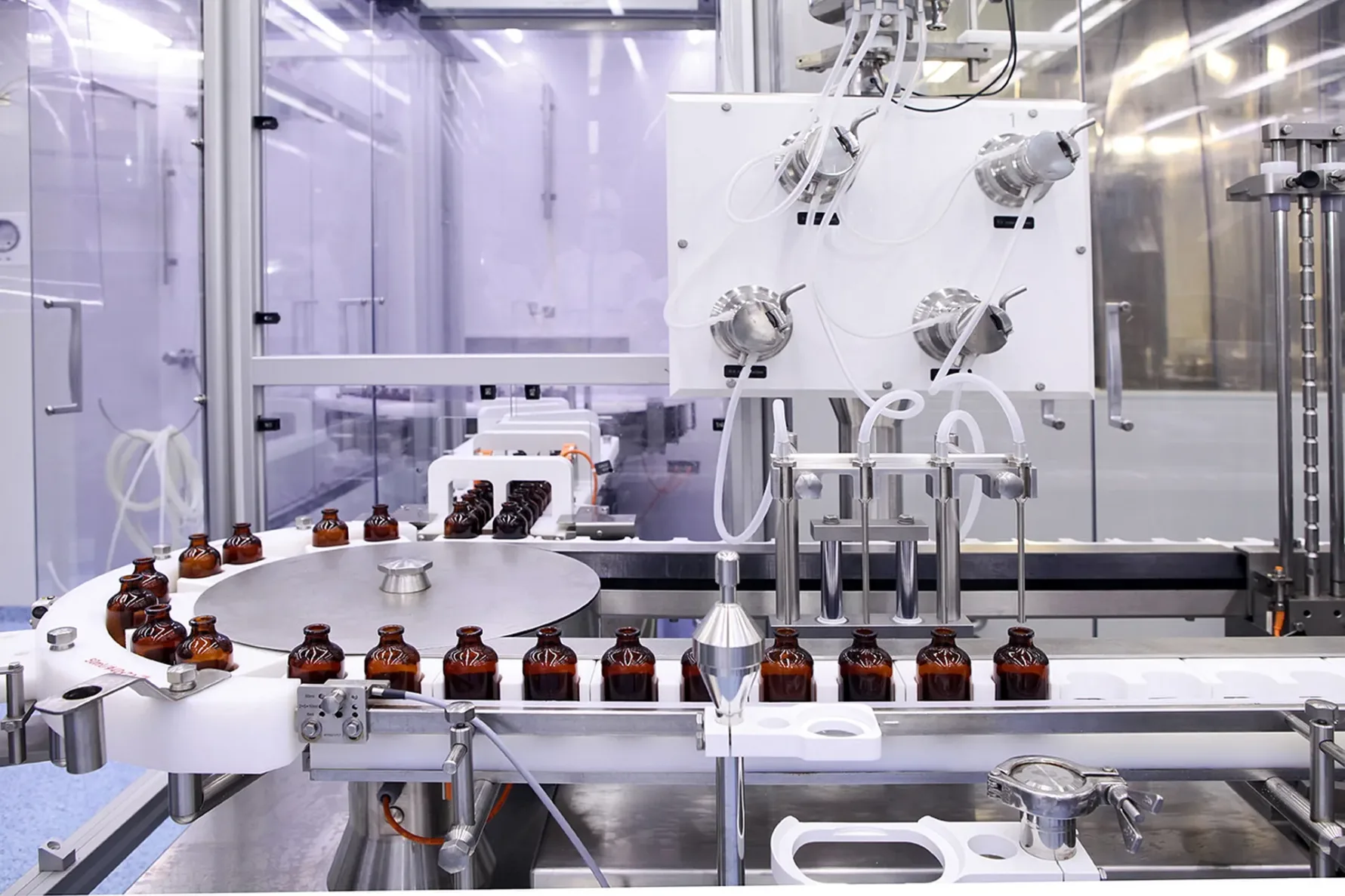 Sterile bottles and ampoules on the dispensing line at a pharmaceutical manufacturing facility
